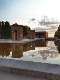 Reflection of building in swimming pool against sky