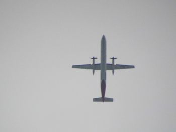 Low angle view of airplane against clear sky