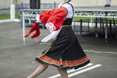 A girl dances russian folk dance. performance of a girl with a folk dance on the street. person