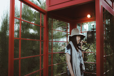 Woman using telephone booth