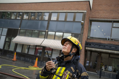 Firefighter talking via walkie talkie