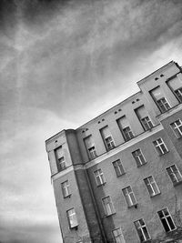 Low angle view of building against cloudy sky