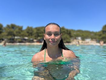 Portrait of woman swimming in pool