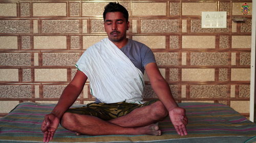 Portrait of young man sitting at home