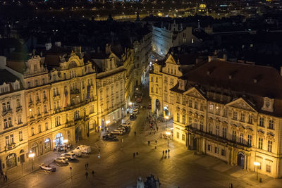 High angle view of people on street amidst buildings at night
