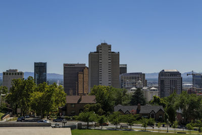 Buildings in city against clear sky