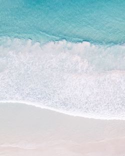 High angle view of waves rushing towards shore