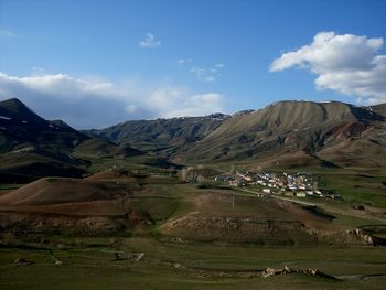 Scenic view of landscape and mountains against sky