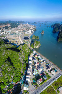 High angle view of river amidst cityscape against sky