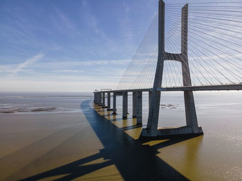 View of bay bridge against cloudy sky