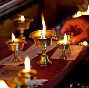 Close-up of lit candle in dark room