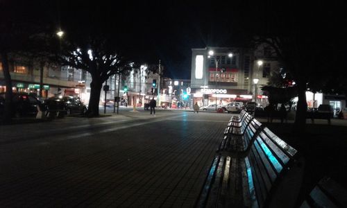 Illuminated city against sky at night