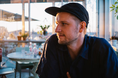 Young man looking away in cafe