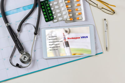 High angle view of computer keyboard and stethoscope on paper