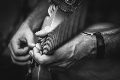 Midsection of man playing guitar