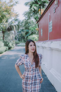 Portrait of beautiful young woman standing outdoors