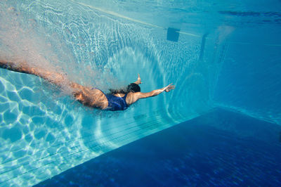 High angle view of man swimming in pool