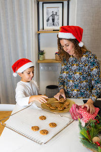 Mother and son with a cookies fresh from the oven at christmas