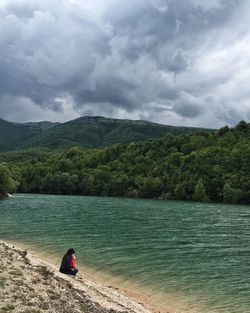 Scenic view of lake against cloudy sky