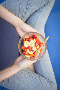 Midsection of woman holding bowl