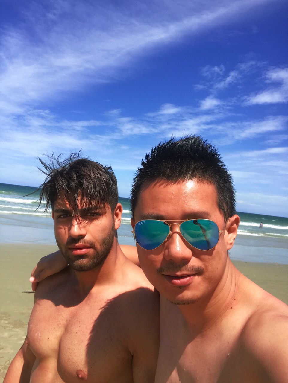 beach, looking at camera, portrait, sky, young men, sunglasses, two people, vacations, real people, lifestyles, men, headshot, young adult, togetherness, leisure activity, sea, close-up, day, shirtless, outdoors, people, only men, adult, adults only, holi