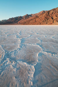 Scenic view of desert against clear blue sky