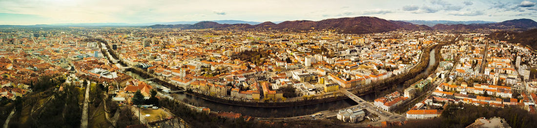 Graz hill schlossberg in austria, cityscape with house roofs, mur river