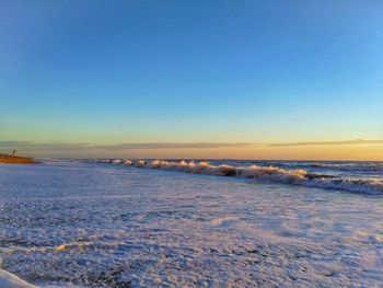 Scenic view of frozen sea against clear blue sky