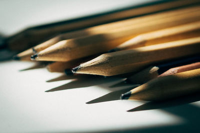 Close-up of pencils over white background