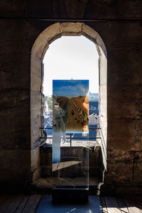 Buildings seen through arch window