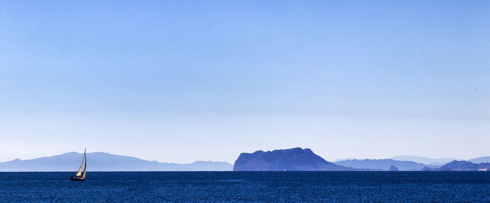 Sailboat in sea against sky