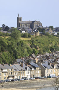 Houses in city against clear sky