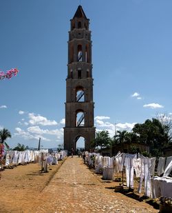 Clothes drying by historic church against sky
