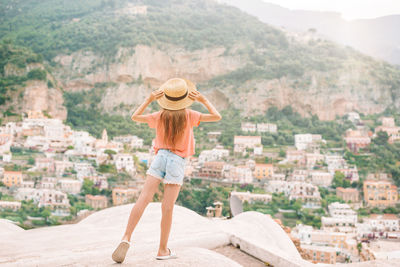 Rear view of woman looking at cityscape