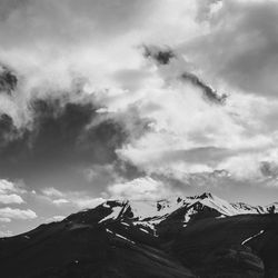 Scenic view of mountains against cloudy sky