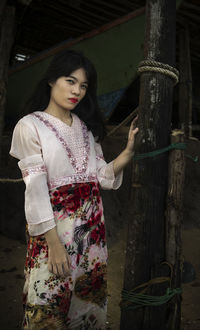 Young woman looking at camera while standing outdoors