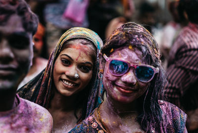 Portrait of smiling woman with multi colored umbrellas