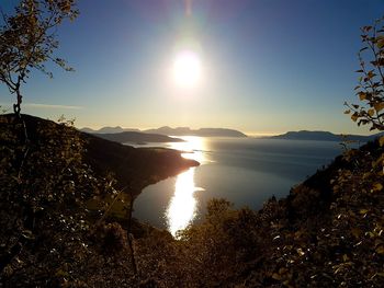 Scenic view of mountains against bright sun