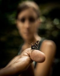Cropped image of woman holding flower