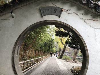 Rear view of people walking on road