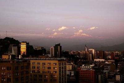 City buildings against sky during sunset