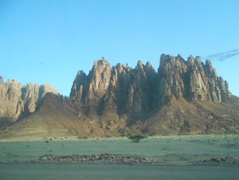 Panoramic view of sea and mountains against clear blue sky