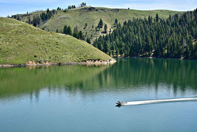 Scenic view of lake by tree mountain