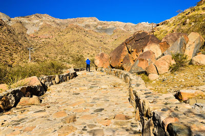 Full length of woman standing on rock formation