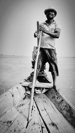 Portrait of man standing in front of sea against sky