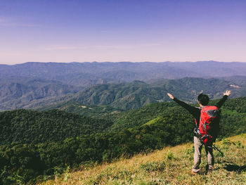 Man standing on mountain against sky