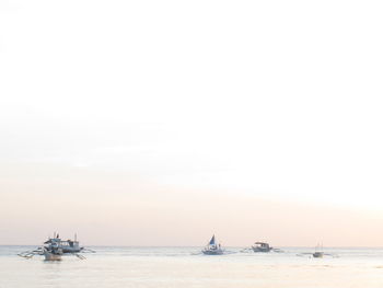 Boat sailing in sea against sky