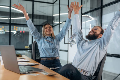 Portrait of female friends doing yoga at office