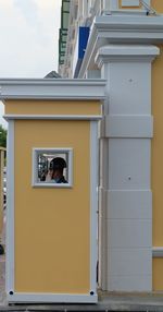 Security guard seen through window of cabin