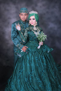 Portrait of young couple standing outdoors